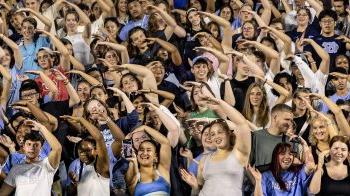 First-year students doing cheers at a pep rally event at Kenan Stadium.